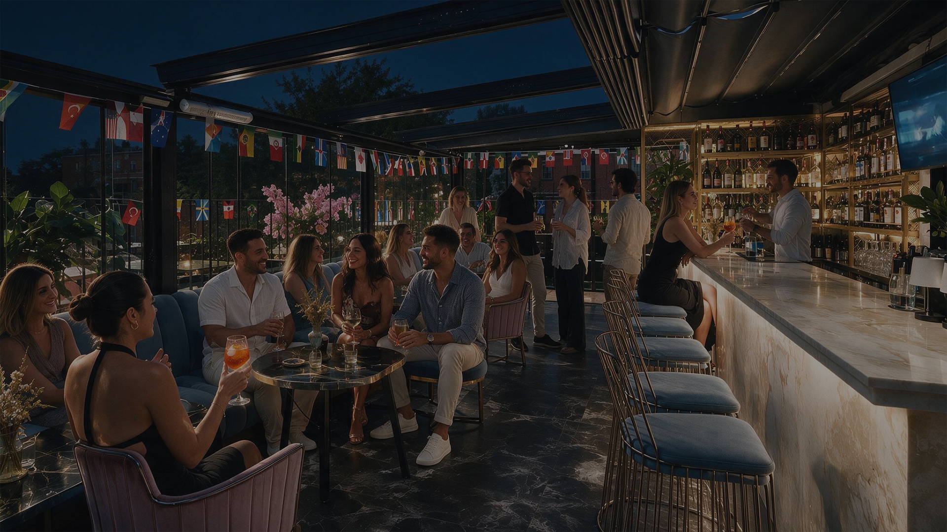 Guests dining beneath warm lights on a rooftop at sunset